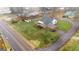 Aerial view of a quaint home with a metal roof, carport, and a spacious yard in a residential neighborhood at 110 Bevis Cir, Bowdon, GA 30108