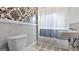 Cozy bathroom featuring vintage-style wallpaper, a toilet, and a tub/shower with curtain at 110 Bevis Cir, Bowdon, GA 30108