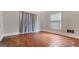 Serene bedroom showcasing hardwood floors and a sun-drenched window for a restful ambiance at 110 Bevis Cir, Bowdon, GA 30108