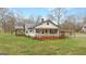 Quaint single-story home with a covered carport and metal roof, surrounded by a green lawn at 110 Bevis Cir, Bowdon, GA 30108