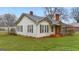 Cozy single-story home featuring a metal roof, red brick accents, and a covered carport at 110 Bevis Cir, Bowdon, GA 30108