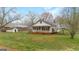 Classic single-story home with a metal roof and covered porch, nestled in a well-maintained lawn at 110 Bevis Cir, Bowdon, GA 30108