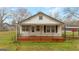 Charming single-story home featuring a brick porch and black railing, offering a welcoming curb appeal at 110 Bevis Cir, Bowdon, GA 30108