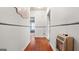 Hallway showcases original hardwood floors leading to the various rooms and an older heater at 110 Bevis Cir, Bowdon, GA 30108