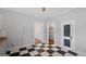 A kitchen with black and white checkered floors and vintage cabinets at 110 Bevis Cir, Bowdon, GA 30108