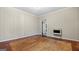 Cozy living room features weathered floors, light-colored walls, and a wall heater for comfort at 110 Bevis Cir, Bowdon, GA 30108