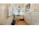 Bright sunroom featuring wood paneling, and curtains for a cozy, sunlit space at 110 Bevis Cir, Bowdon, GA 30108