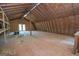 Spacious attic featuring a wooden floor and exposed wooden beams, offering ample storage or conversion potential at 225 Banks Rd, Fayetteville, GA 30214