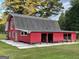 Charming red barn with a gambrel roof, providing versatile space for various uses and a rustic aesthetic at 225 Banks Rd, Fayetteville, GA 30214