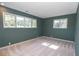 A carpeted bedroom with green walls and natural light from two windows at 225 Banks Rd, Fayetteville, GA 30214