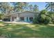 Ranch-style home with covered parking, a spacious yard, and a cozy outdoor seating area at 225 Banks Rd, Fayetteville, GA 30214