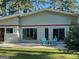 Ranch-style home boasts a welcoming patio and outdoor seating area at 225 Banks Rd, Fayetteville, GA 30214