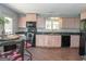 The kitchen has light cabinets and tile floors, black appliances, and granite countertops at 225 Banks Rd, Fayetteville, GA 30214