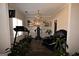 Exercise room featuring sleek floors, chandelier, and an assortment of workout equipment at 110 Cardinal Ridge Ct, Fayetteville, GA 30214