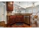 Kitchen featuring dark wood cabinetry, stainless steel appliances, granite counters, and view to breakfast nook at 37 Water Oak Dr, Sharpsburg, GA 30277