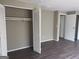 Bright bedroom with wood-look laminate flooring, closet space, and neutral walls at 923 Regal Path Ln, Decatur, GA 30030