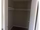 Empty closet with shelf and hanging rod with wood-look laminate flooring at 923 Regal Path Ln, Decatur, GA 30030