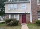 Charming townhome with brick and siding, featuring white shutters and a red front door at 923 Regal Path Ln, Decatur, GA 30030