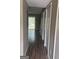 Hallway with wood-look laminate flooring leading to a living area and closet spaces at 923 Regal Path Ln, Decatur, GA 30030