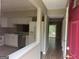 Open layout showcasing kitchen with stainless steel appliances flowing into the living area at 923 Regal Path Ln, Decatur, GA 30030