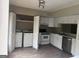 Updated kitchen features white cabinetry, stainless steel appliances, and a convenient laundry closet at 923 Regal Path Ln, Decatur, GA 30030