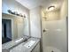 Bathroom features a large mirror and vanity next to a shower at 246 Bridgewood Se Dr, Conyers, GA 30094