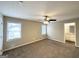 Large bedroom featuring neutral paint and carpet flooring, with natural light from two windows at 246 Bridgewood Se Dr, Conyers, GA 30094