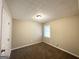 Bedroom with neutral walls, carpet, and a window letting in natural light at 246 Bridgewood Se Dr, Conyers, GA 30094