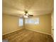 Large carpeted bedroom featuring natural light, ceiling fan, and three bright windows at 2922 Dale Pl, Decatur, GA 30032