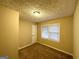 Cozy bedroom featuring neutral walls, carpeted floors, and a bright window with natural light at 2922 Dale Pl, Decatur, GA 30032