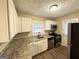 Functional kitchen features granite countertops, stainless steel appliances and white cabinets at 2922 Dale Pl, Decatur, GA 30032