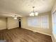 Bright living room with wood floors, ceiling fan, and abundant natural light through large windows at 2922 Dale Pl, Decatur, GA 30032