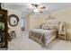 Comfortable bedroom with a ceiling fan, carpet, and decoratively styled furniture at 4186 Highway 138 Sw, Stockbridge, GA 30281