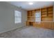 Bedroom features a built in desk and shelving with neutral carpet at 60 Paden St, Covington, GA 30016