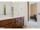 Bathroom with a wooden vanity and a white countertop. There is a mirror above the sink and a bedroom is visible through the doorway at 135 Antoinette Ave, Mcdonough, GA 30252