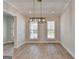 Dining room with hardwood floors, pendant lighting fixture, and natural light from two windows at 4368 Burton Bend Way, Buford, GA 30518