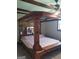 Primary bedroom with wood flooring and unique four-poster bed at 9000 Edinburg Dr, Winston, GA 30187