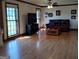 Cozy living room featuring hardwood floors, a comfortable couch, and a TV at 9000 Edinburg Dr, Winston, GA 30187