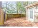 Private backyard featuring a brick paver patio, mature trees and privacy fence at 44 Star Spangled Ln, Peachtree City, GA 30269