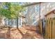 Backyard with a brick paver patio, privacy fence, and lush trees at 44 Star Spangled Ln, Peachtree City, GA 30269