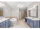 Primary bathroom with a soaking tub, double sinks, and a glass shower at 44 Star Spangled Ln, Peachtree City, GA 30269