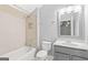 Bathroom with bathtub, tiled shower and vanity with mirror, offers comfort and functionality at 44 Star Spangled Ln, Peachtree City, GA 30269