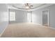 Large bedroom featuring tray ceilings, a ceiling fan, and plenty of natural light at 44 Star Spangled Ln, Peachtree City, GA 30269