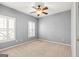 Bedroom featuring neutral carpet flooring, ceiling fan, and shuttered windows for natural light control at 44 Star Spangled Ln, Peachtree City, GA 30269