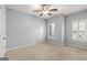 Comfortable bedroom with neutral carpet, ceiling fan, and windows offering natural light at 44 Star Spangled Ln, Peachtree City, GA 30269