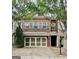 Charming two-story brick home with a two-car garage and lovely, light-blue shutters at 44 Star Spangled Ln, Peachtree City, GA 30269