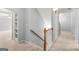 Hallway with a staircase and a view of an adjacent room with built-in shelving at 44 Star Spangled Ln, Peachtree City, GA 30269