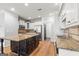 Updated kitchen with a large center island, granite countertops, stainless steel appliances, and white cabinets at 44 Star Spangled Ln, Peachtree City, GA 30269