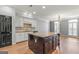Bright kitchen with a large center island, granite countertops, stainless steel appliances, and white cabinets at 44 Star Spangled Ln, Peachtree City, GA 30269