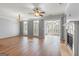 Bright living room with hardwood floors, a fireplace, large windows, and a ceiling fan for added comfort at 44 Star Spangled Ln, Peachtree City, GA 30269